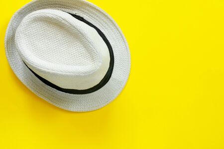 Fashionable straw white hat on yellow paper background.
Flat lay, top view, copy space concept.の写真素材