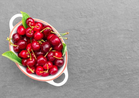 Fresh crop of cherry berries on a stone gray countertop.
Flat lay, top view, copy space concept.の写真素材