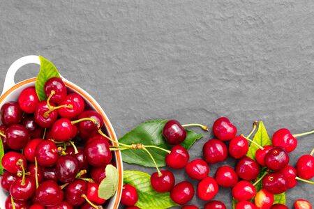 Fresh crop of cherry berries on a stone gray countertop.
Flat lay, top view, copy space concept.の写真素材