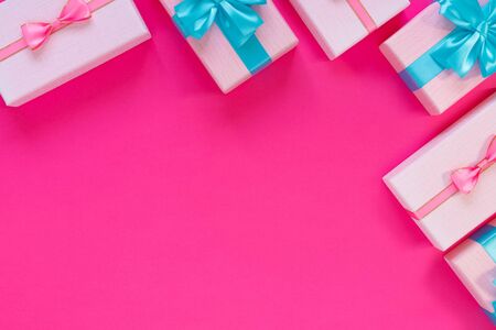 Set of beautiful gift boxes with blue bows on pink background. Holiday sale.
Copy space for your...