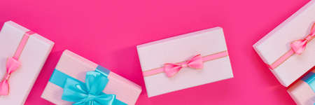 Banner from set of beautiful gift boxes with blue bows on pink background. Holiday sale. Copy space...