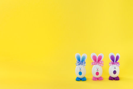 Funny easter bunnies on bright yellow background. Happy easter card.