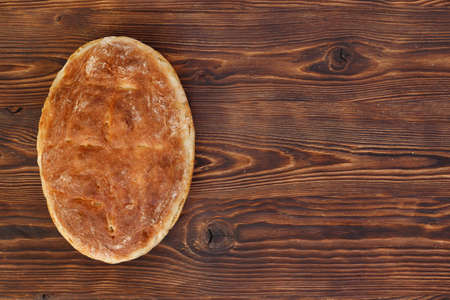 Fresh homemade wheat bread on wooden table. Flat lay, top view, copy space concept.の写真素材