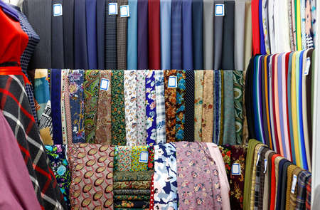 Various multicolored textiles for sale in fabric shop