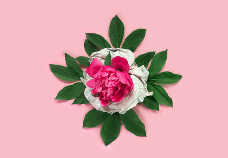Bouquet of beautiful delicate pink peonies with vintage wrapping paper on background. Minimal...