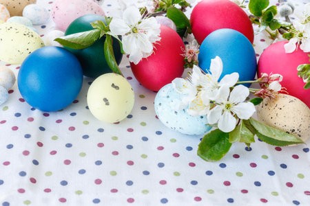 Beautiful Easter card with colorful eggs and cherry branches on paper pink background. Floral...