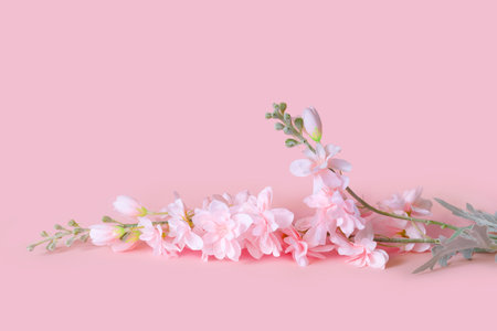 Bouquet of delicate artificial flowers on pink background. Decorative floral in the interior of the house.の写真素材