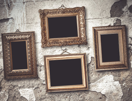 Gilded wooden frames for pictures on old stone wallの写真素材