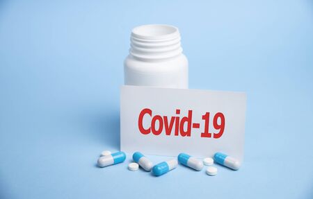 Covid-19 text on card with medical bottle. covid conceptの写真素材