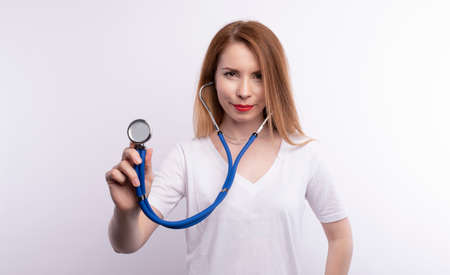 Portrait Of Smiling Female Doctor Wearing White Coat With Stethoscopeの写真素材