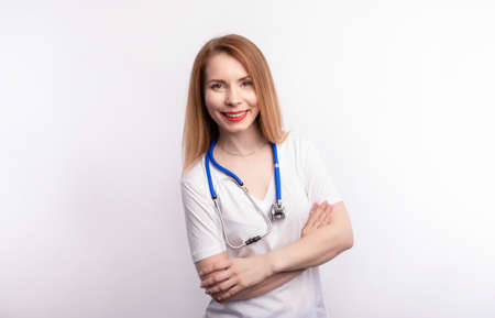 Portrait Of Smiling Female Doctor Wearing White Coat With Stethoscope.の写真素材