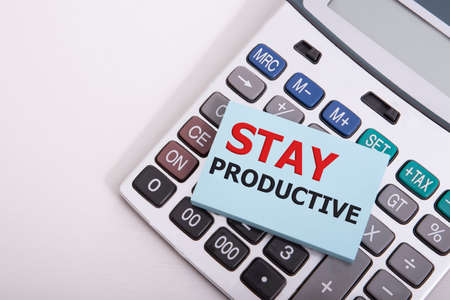 Word writing Stay Productive in the office on calculator Business concept for Concentration...