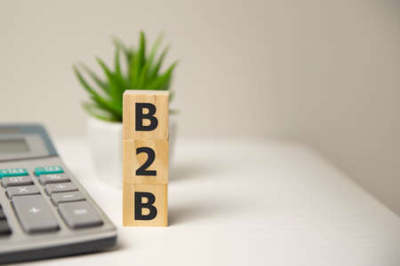 B2B word made of wooden cubes on a white background with copy space, business concept.の写真素材