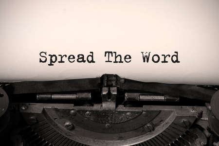 Word writing text Spread The Word on a vintage typewriterの写真素材