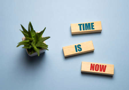 The time is now - words from wooden blocks with letters, the time is now concept, top backgroundの写真素材