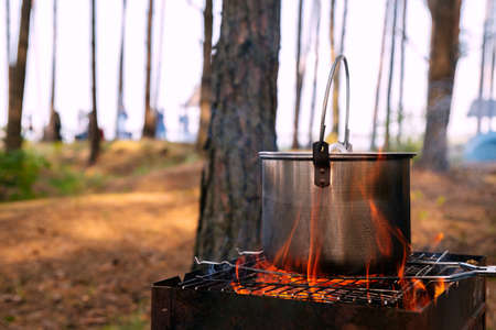 cooking food in pot an open fire during camp of mountain hike.の写真素材