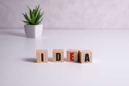 Wooden elements with letter on wooden table spelling word ideaの写真素材
