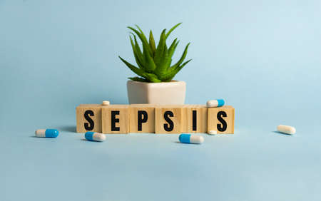 Sepsis word written on wood block. Sepsis text on blue for your desing, concept.の写真素材