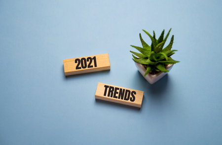 flipping 2020 to 2021 trends print screen on wooden block cubes. New idea business fashion popular and relevant topics.の写真素材