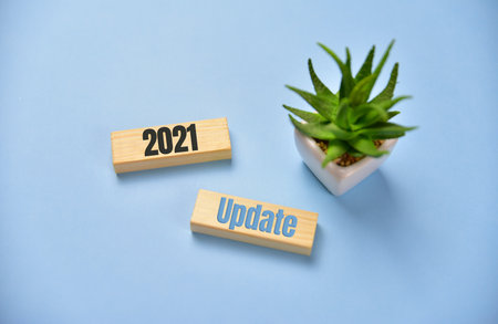 wooden blocks with word update 2021. blue background. Businessの写真素材