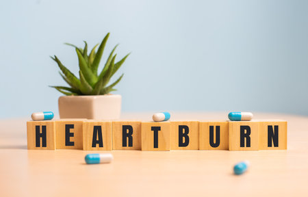 Heartburn word concept on wooden cubes on blueの写真素材