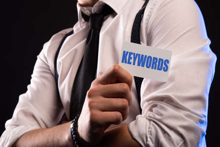 Hand hold letters for KEYWORD concept on cardの写真素材