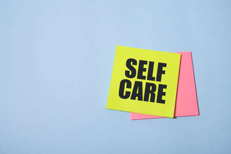 Self care word on stickers wood table. Copy space. White backgroundの写真素材