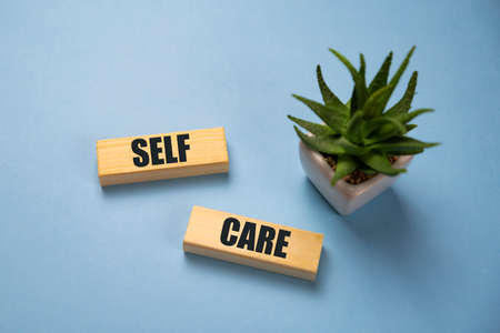 Self-care word on lightbox on blue background flat lay. Take care of yourselfの写真素材
