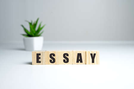 Essay note on a white table in a bright room made of wooden blocksの写真素材