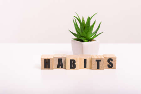 habits Sign with the word habits on a wooden desk in a bright room.の写真素材