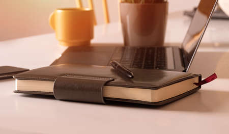 Pen and notebook with laptop.Inspiration moment,workspace or coffee break in the morning selective focus.の写真素材