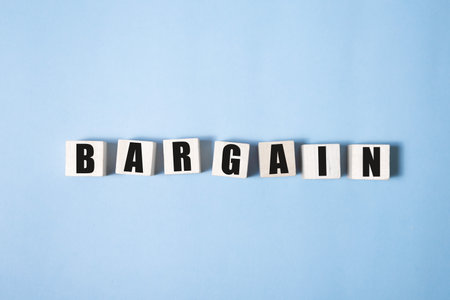 Bargain word concept written on a light table and light backgroundの写真素材