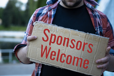 become a sponsor written on card man hand holdingの写真素材