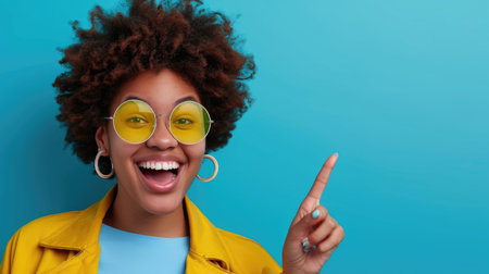 a young woman pointing on a plain blue background, fashionの素材