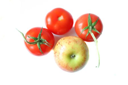 Three ripe tomatoes and appleの写真素材