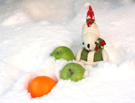 toy mouse in the snow with green apples and orangeの写真素材