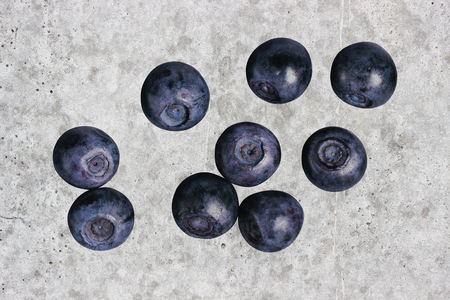 Blueberries on the background of a concrete wallの写真素材