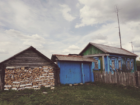 Old wood house with firewood. Rural landscape.の写真素材