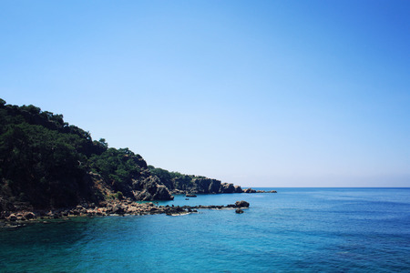 Small beach on the island near Adrasan. Rocky shore. Southern coast of Turkey. Calm blue sea and clear sky. View of Mediterranean Sea. Spring sunny day in Antalya province, Turkey.の写真素材