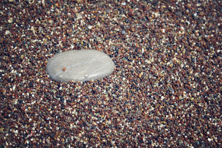 Texture of black and white and brown pebbles. Closeup. Aged photo. Background. Various stones on the beach. Antalya Province, Turkey. Wide photo for site slider.の写真素材