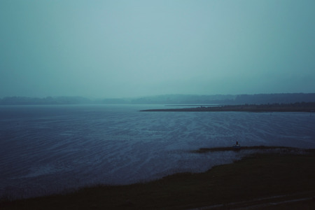 Evening rain over Kenozero lake. Aged photo. Rainy summer night. Russian north. Kenozersky National Parkの写真素材