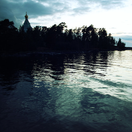 Ladoga lake. Late evening. Saint Nicholas's church on the island (skete). Valaam island. Aged photo. Beautiful churches. Nikolsky monastery. Nicholas The Wonderworker church. Karelia, Russia.の写真素材
