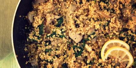 Vegetarian couscous with mushrooms and spinach. Close up. Vegan dish with millet in the frying pan. Top view. Wide photo.の写真素材