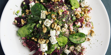 Beetroot salad with cottage cheese, baby spinach and walnuts. European cuisine. Organic food. Vegetarian appetizer. Healthy lifestyle. Simple side dish. Top view. Wide photo.の写真素材