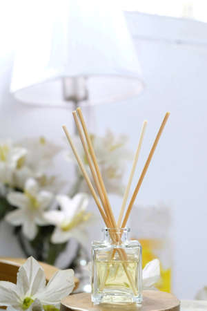 Reed diffuser essential aromatherapy oil with white flowersの写真素材