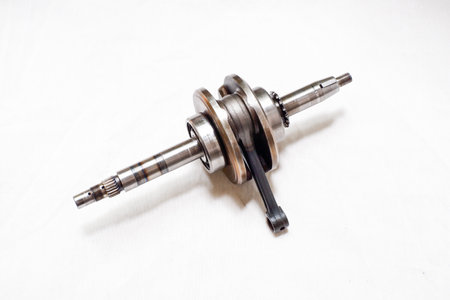old crankshaft for small engine of motorbikes with white backgroundの写真素材