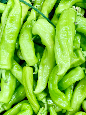 A very detailed close up of fresh green peppers. The light green color is vivid and shining.