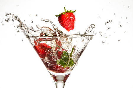 Strawberries Dropping in Martini Glassの写真素材