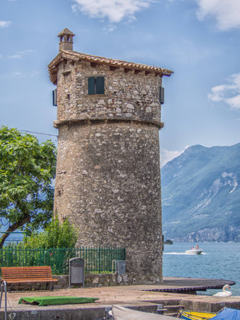 Old tower on the marina of Malcesine town, lake Garda, Italyの写真素材