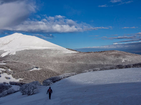 Hiker on the mountains in winter with snow, Apennines, Umbria, Italy
